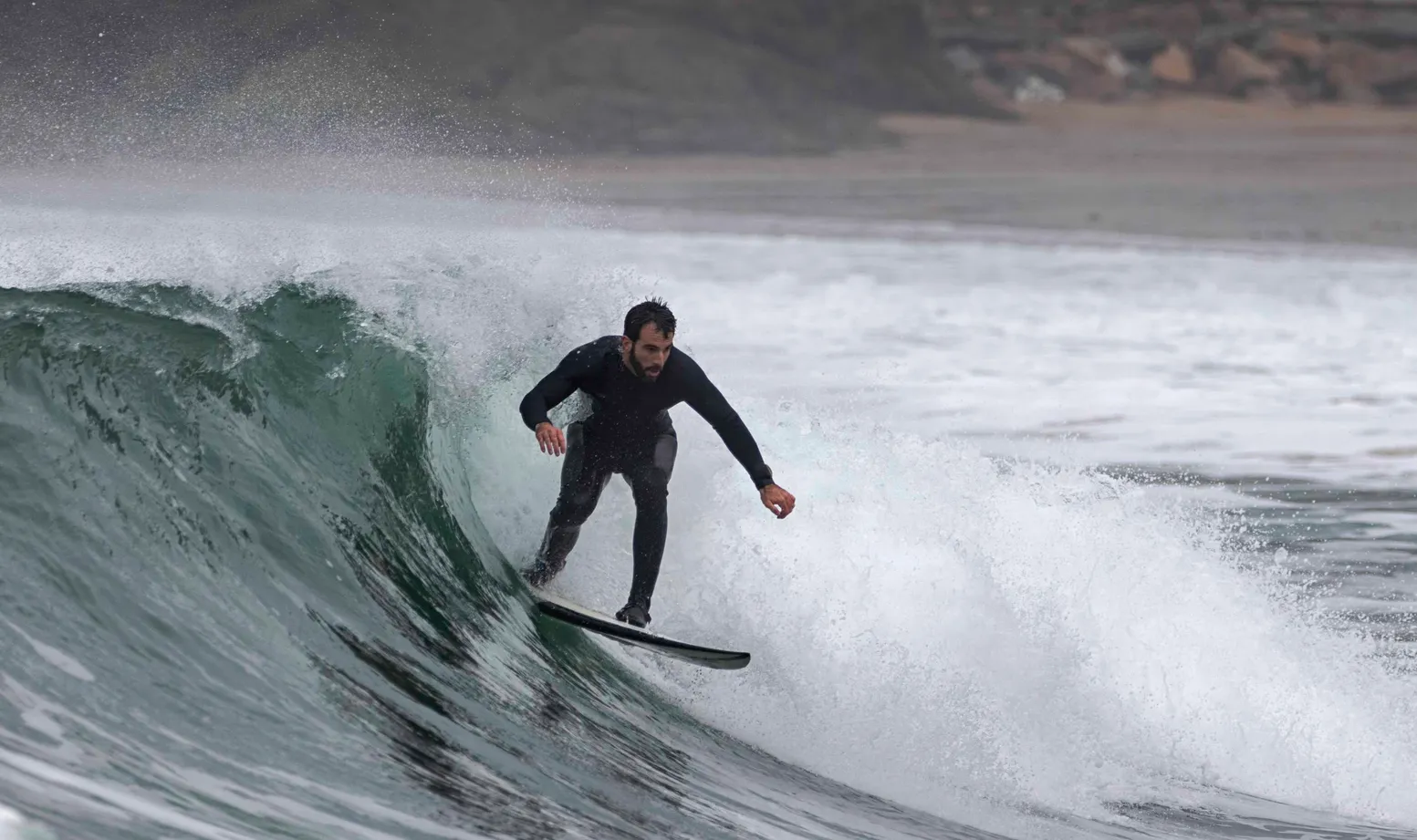 Tomas Madariaga focused surfing a wave